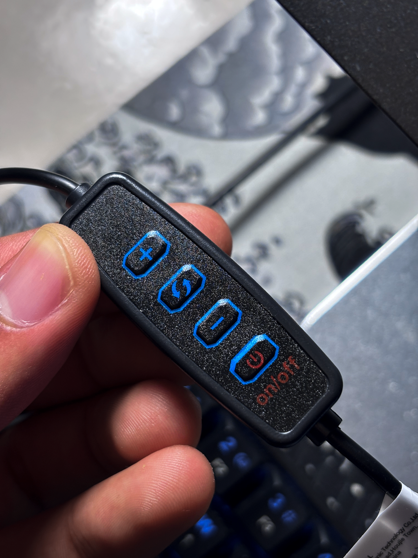Hand adjusting the brightness dial on the light bar